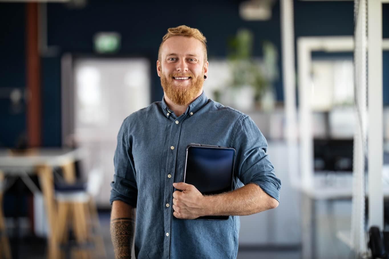 Man holding tablet smiling